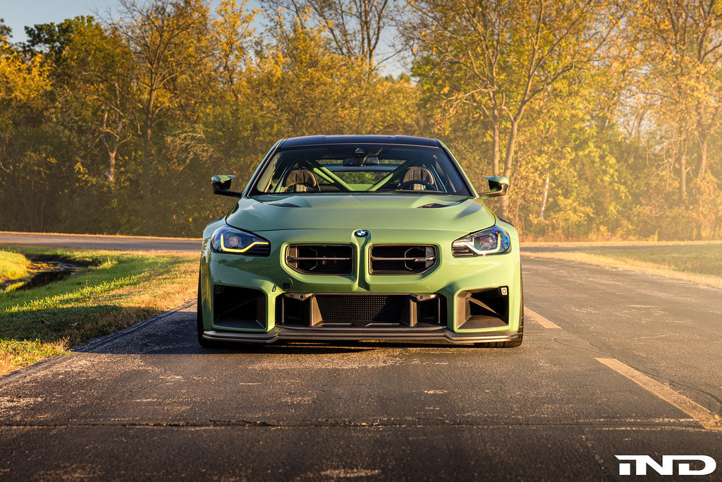 Alpha-N G87 M2 Clubsport carbon vented hood installed on a car, showcasing lightweight, aerodynamic exterior upgrade.