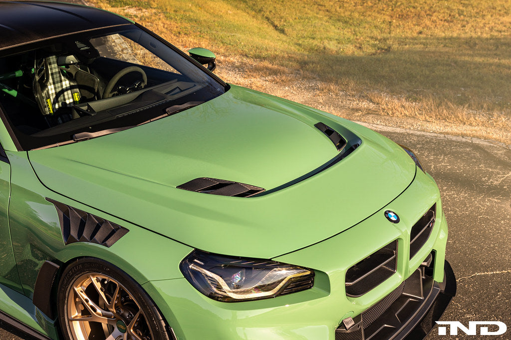 Alpha-N G87 M2 Carbon Vented Hood installed on a car, showing its sleek vented design and lightweight carbon construction.