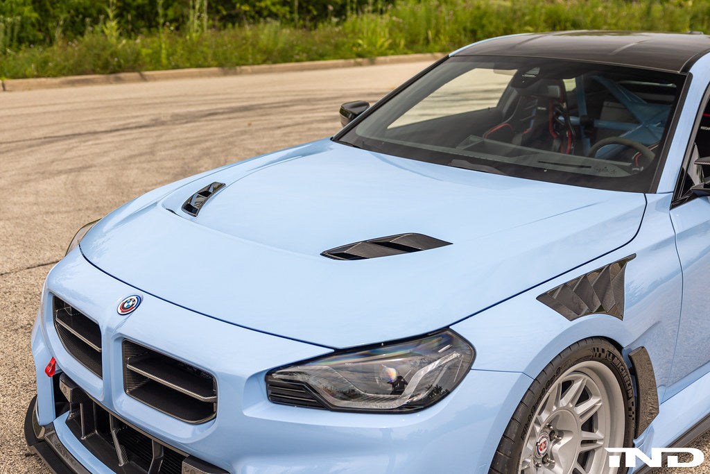 Alpha-N G87 M2 Carbon Vented Hood installed on a vehicle, showcasing the lightweight, vented exterior design for improved airflow.
