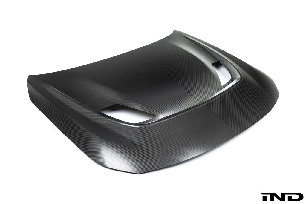 Alpha N G87 M2 Clubsport carbon vented hood on white background, showcasing lightweight exterior car modification.