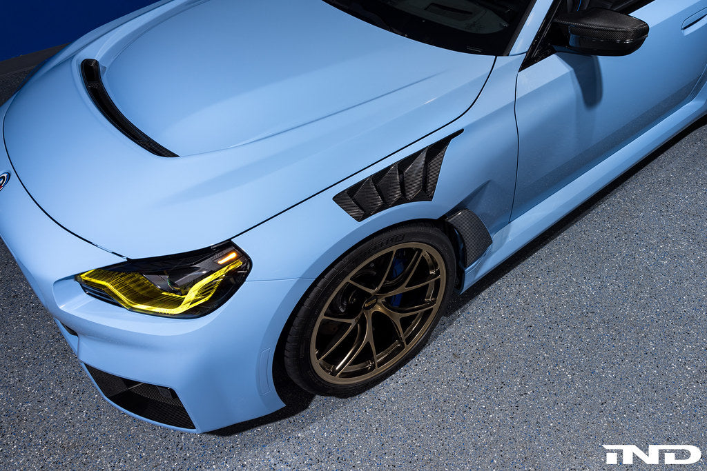 Alpha N G87 M2 carbon vented hood installed on a car, showcasing lightweight exterior design and venting features.