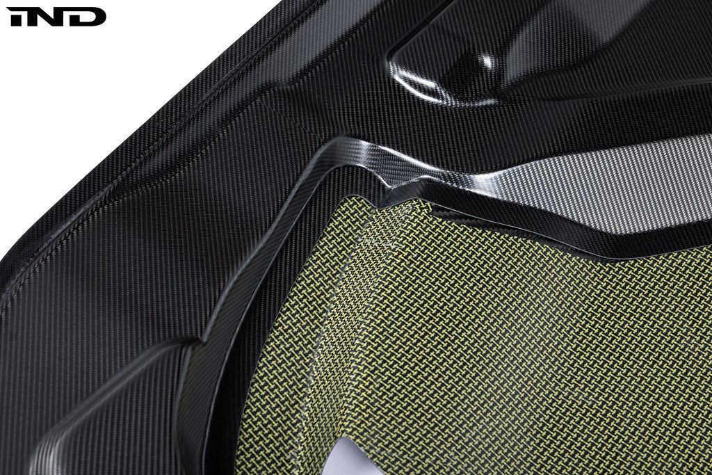 Alpha N G87 M2 carbon vented hood installed on a car, showcasing lightweight, aerodynamic exterior design with white background.