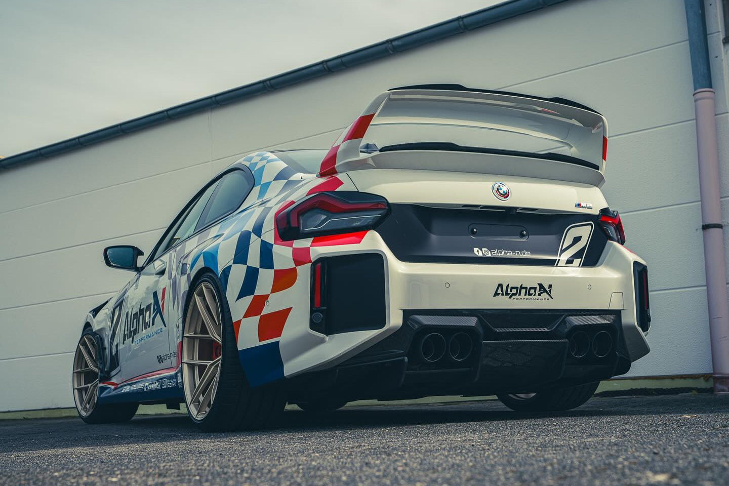 Alpha N G87 M2 Class 3 Wing Gurney Flap installed on a car exterior, highlighting its aerodynamic design and fitment.