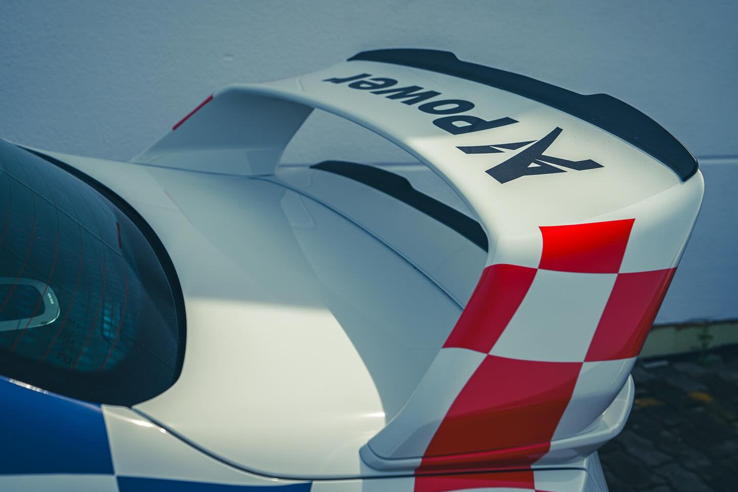 Alpha N G87 M2 Class 3 Wing Gurney Flap set installed on a vehicle exterior, showcasing aerodynamic enhancement features.