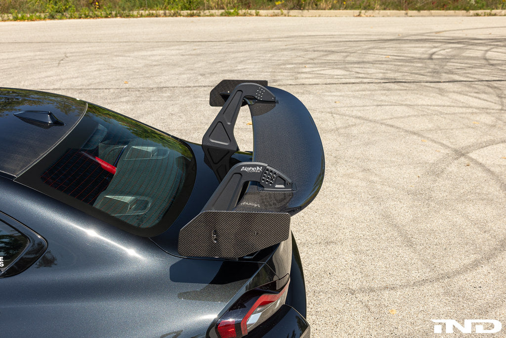 Alpha N G87 M2 GT3 exterior swan neck rear wing installed on a car, showcasing aerodynamic design and high-performance racing features.