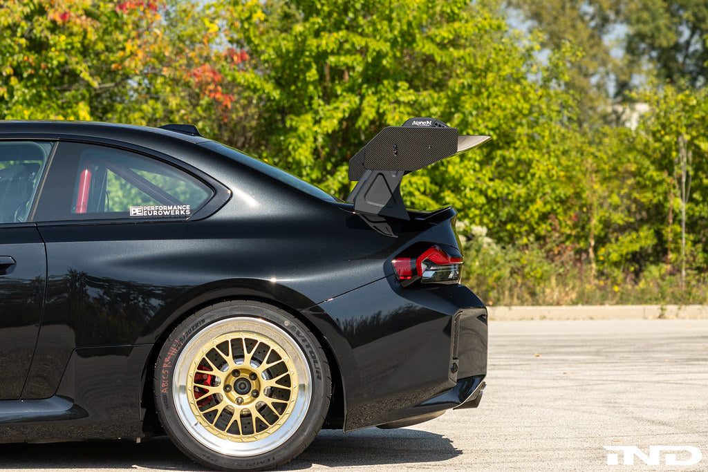 Alpha N G87 M2 GT3 Swan Neck Rear Wing installed on a car, showcasing its aerodynamic design and exterior racing style.