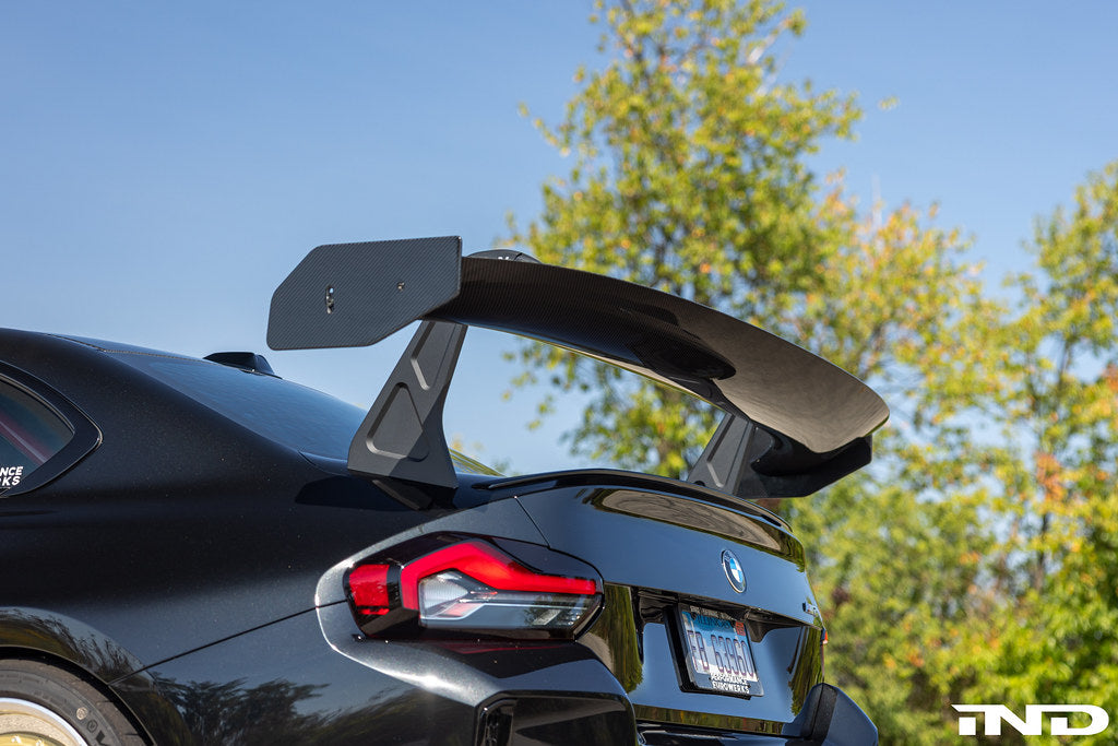 Alpha N G87 M2 GT3 swan neck rear wing installed on a car, showcasing its aerodynamic design and sleek exterior profile.
