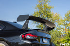 Alpha N G87 M2 GT3 swan neck rear wing installed on a car, showcasing its aerodynamic design and sleek exterior profile.