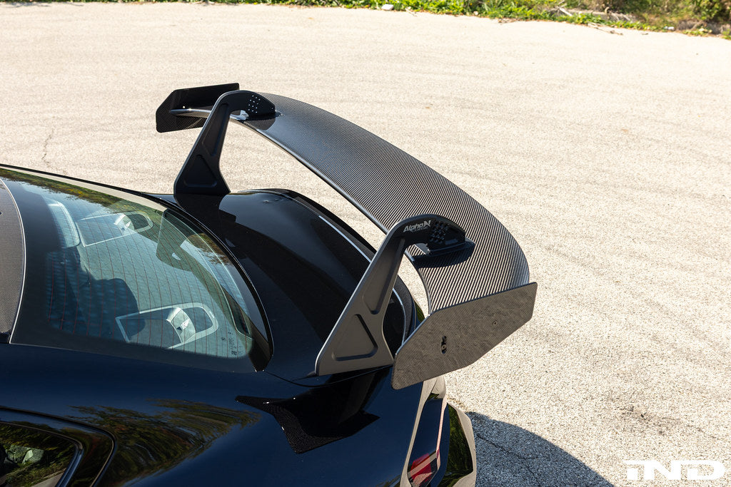 Alpha N G87 M2 GT3 exterior swan neck rear wing installed on a car, showcasing aerodynamic design and performance features.