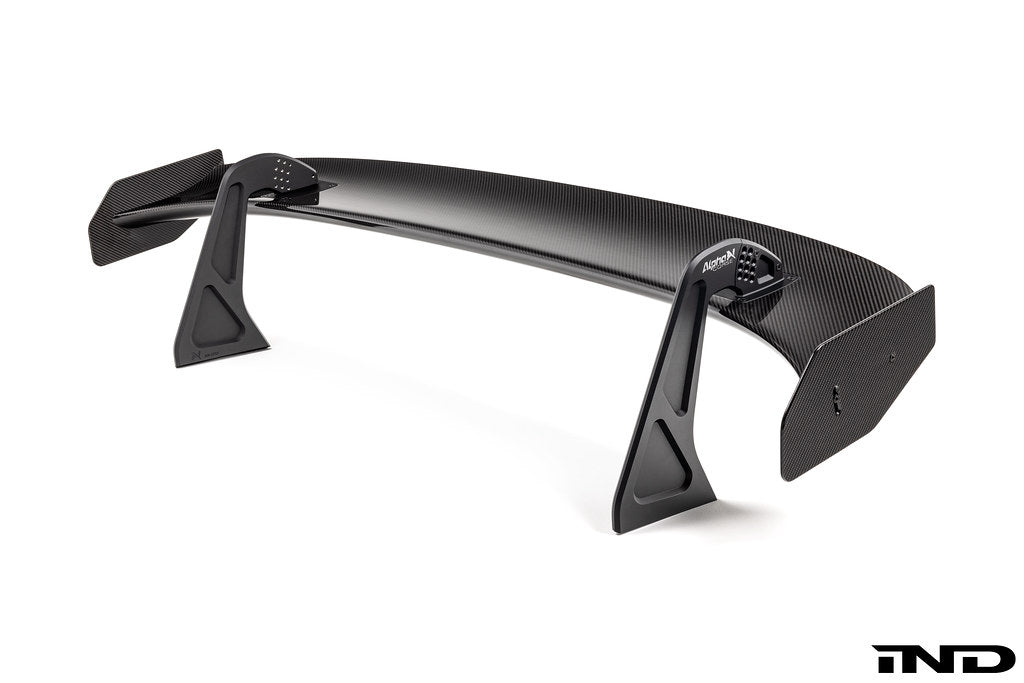 White Alpha N Corse Swan Neck Rear Wing mounted on a car, showcasing its aerodynamic design and sleek exterior style.
