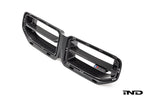 Alpha N G87 M2 LCI front grille emblem retainer with BMW OEM M2 badge installed on the exterior of a BMW M2 G87.