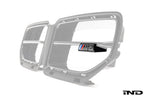 Alpha N G87 M2 LCI front grille emblem retainer with BMW OEM M2 badge installed on the vehicle exterior.