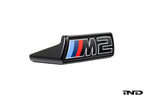 Alpha N G87 M2 LCI front grille emblem retainer with BMW OEM M2 badge on a white background