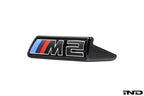 Alpha-N G87 M2 LCI front grille emblem retainer with BMW OEM M2 badge on white background.