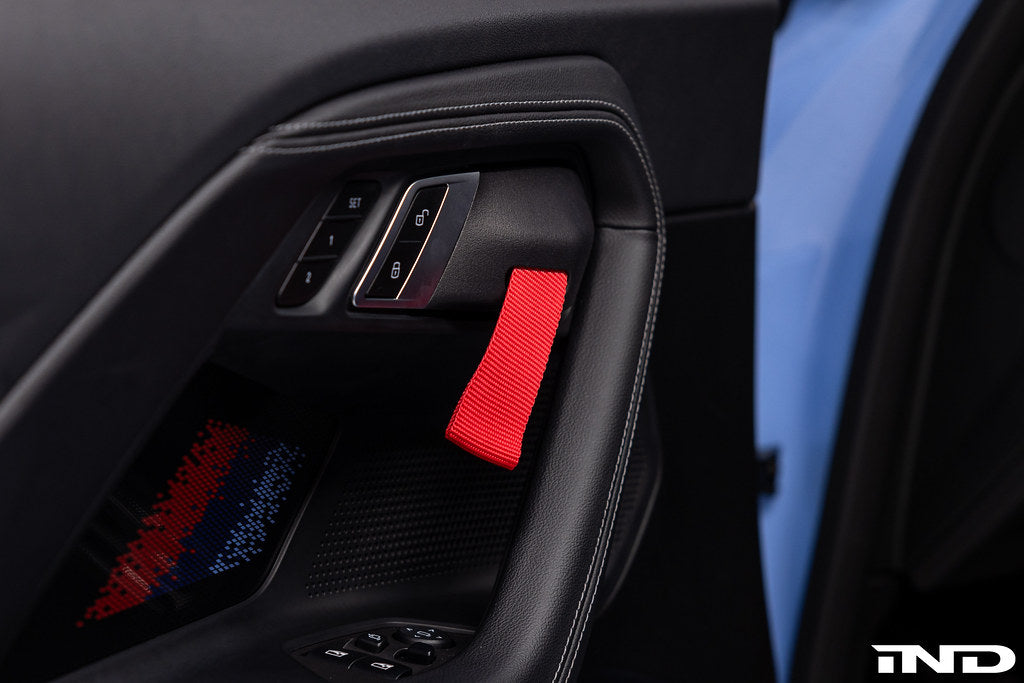 Interior view of the Alpha N G87 M2 Motorsport door pull kit installed, showcasing sleek, performance-inspired door handles.