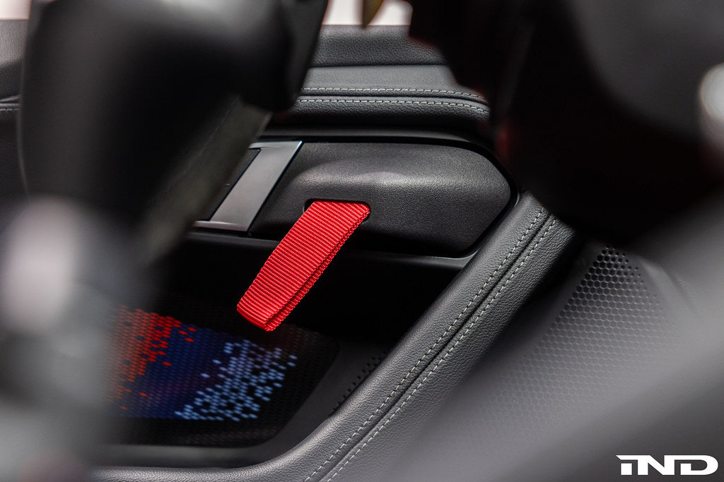 Alpha N G87 M2 interior door pull kit installed, showcasing sleek metal handles for sporty, stylish vehicle interior upgrade.