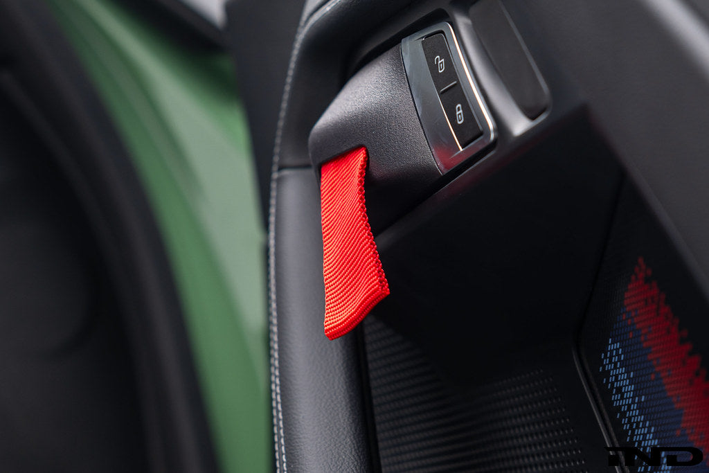 Alpha N G87 M2 Motorsport interior door pull kit installed, featuring sleek handles and ergonomic design for enhanced grip.