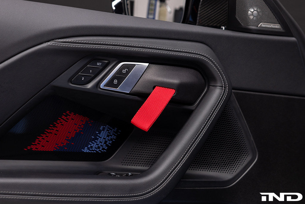 Alpha N G87 M2 Motorsport interior door pull kit installed, featuring sleek design and high-quality materials for enhanced grip.