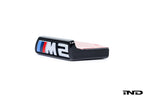 Alpha N G87 M2 front grille emblem retainer for Pre-LCI BMW, shown on a white background. Exterior car accessory.
