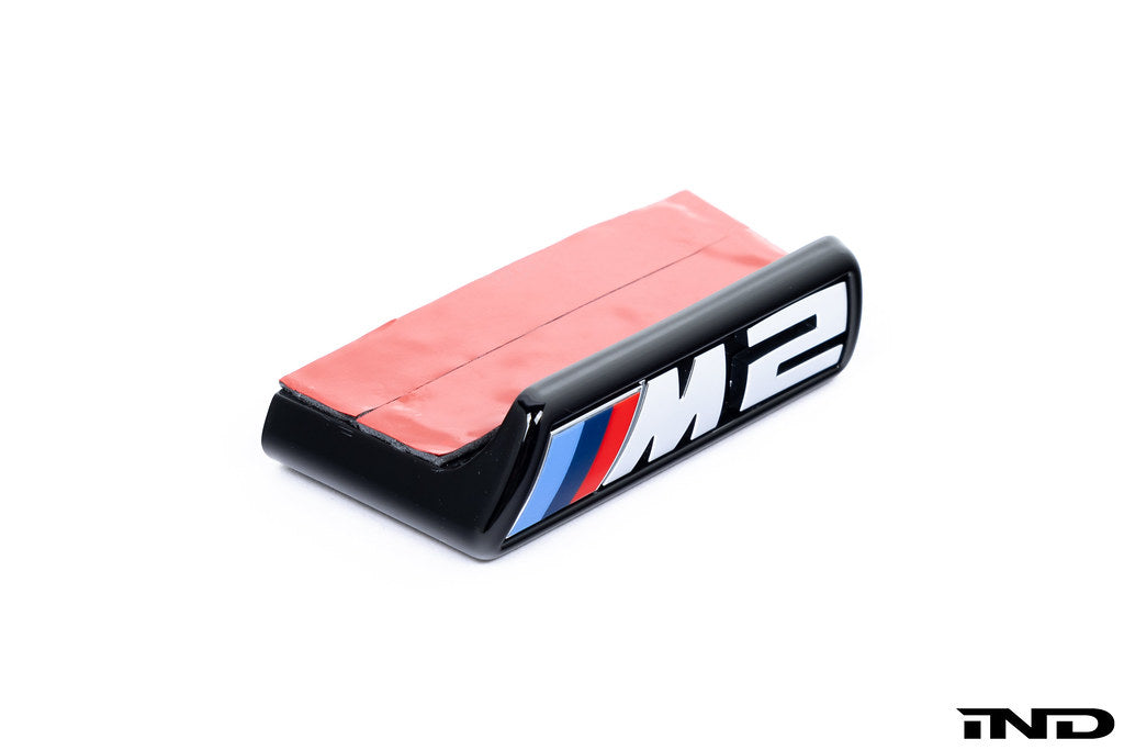 Alpha N G87 M2 front grille emblem retainer for Pre-LCI models, exterior car part with white background.