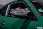 Alpha N G8X M2 M3 M4 carbon mirror cap set installed on a vehicle, showcasing sleek, lightweight exterior mirror covers.