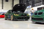 Alpha N G8X M3 M4 carbon front spoiler canard set installed on vehicle, showcasing sleek aerodynamic exterior upgrade.