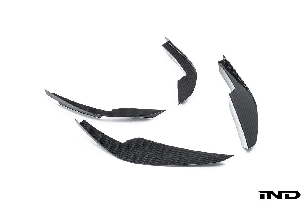 Alpha N G8X M3 M4 carbon canard set installed on exterior of white background, showcasing aerodynamic design for BMW M series.