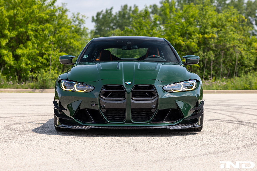 Alpha N G8X M3 M4 carbon front spoiler installed on exterior of vehicle, showcasing sleek aerodynamic design.