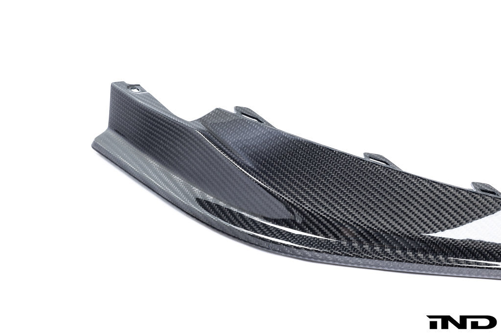 Alpha N G8X M3 M4 carbon front spoiler mounted on a white background, showcasing its aerodynamic exterior design.