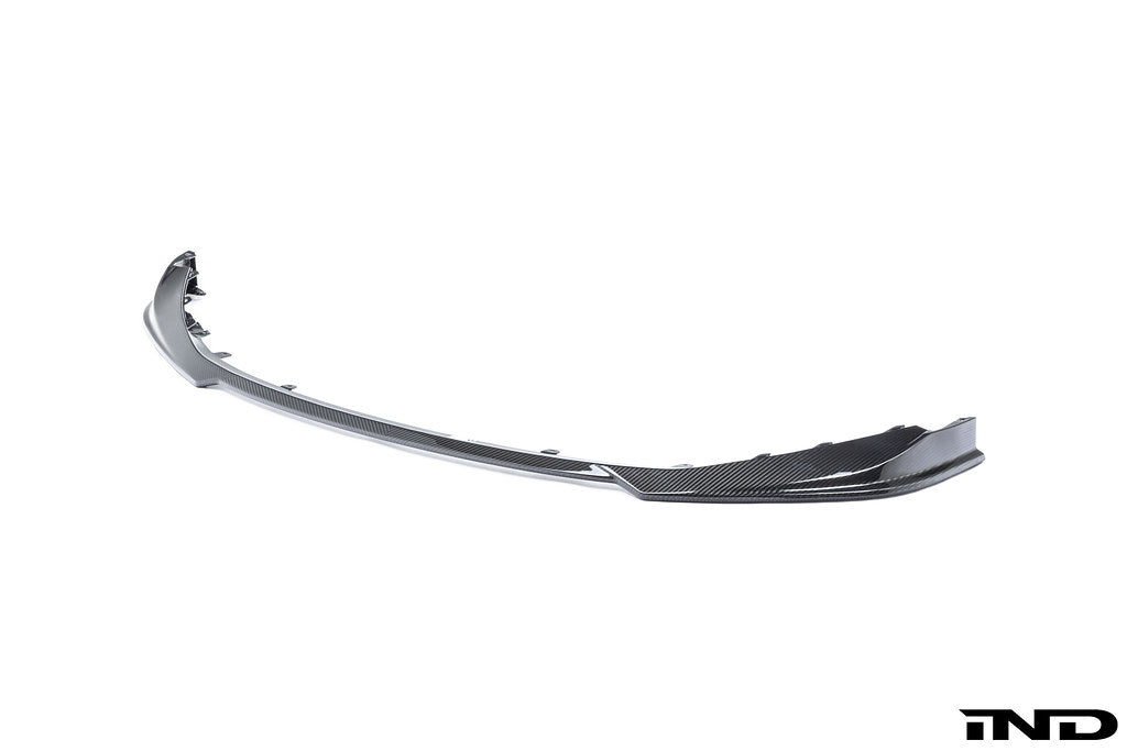 Alpha N G8X M3 M4 carbon front spoiler mounted on a white background, showcasing its aerodynamic design and lightweight carbon material.