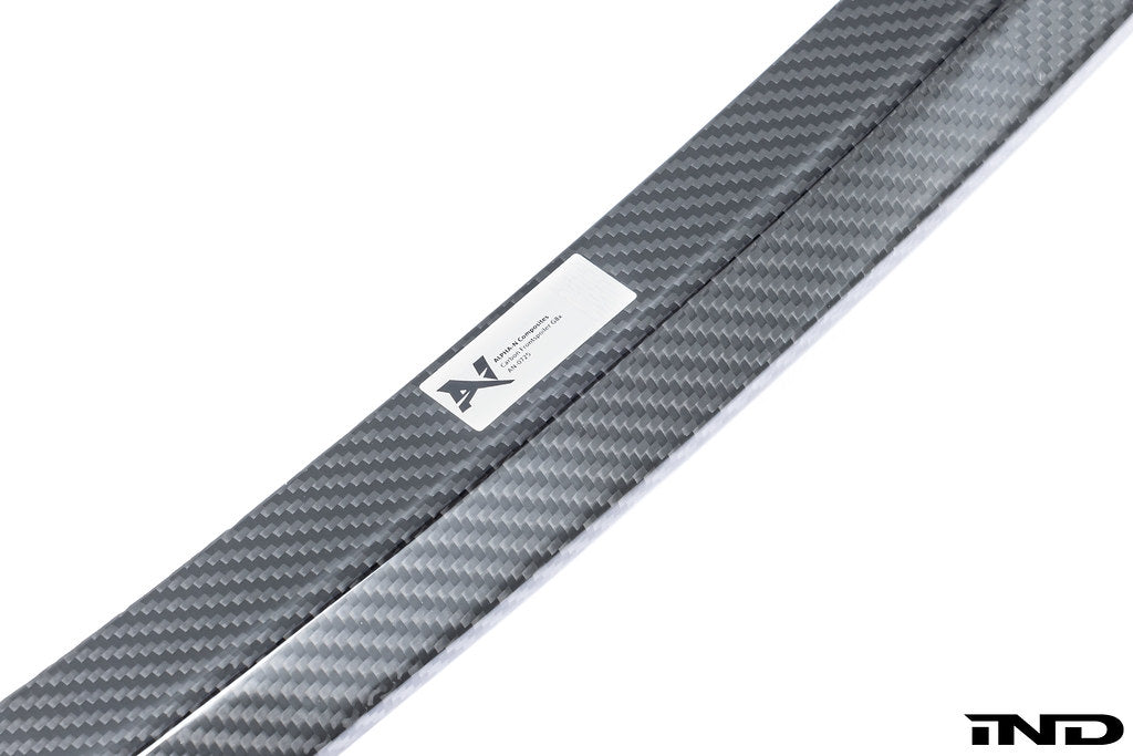 Alpha N G8X M3 M4 carbon front spoiler installed on a white background, showcasing its sleek exterior design and lightweight construction.