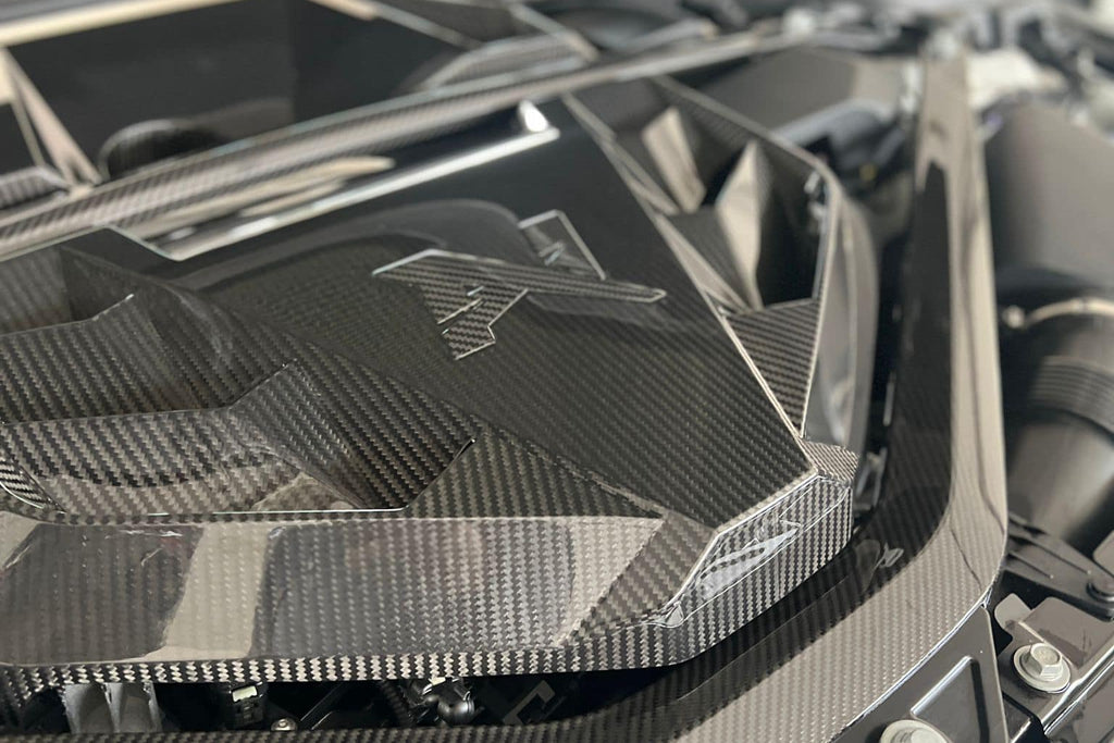 Alpha N G8X S58 carbon engine cover installed on exterior of M2, M3, or M4 BMW with sleek black carbon fiber finish.