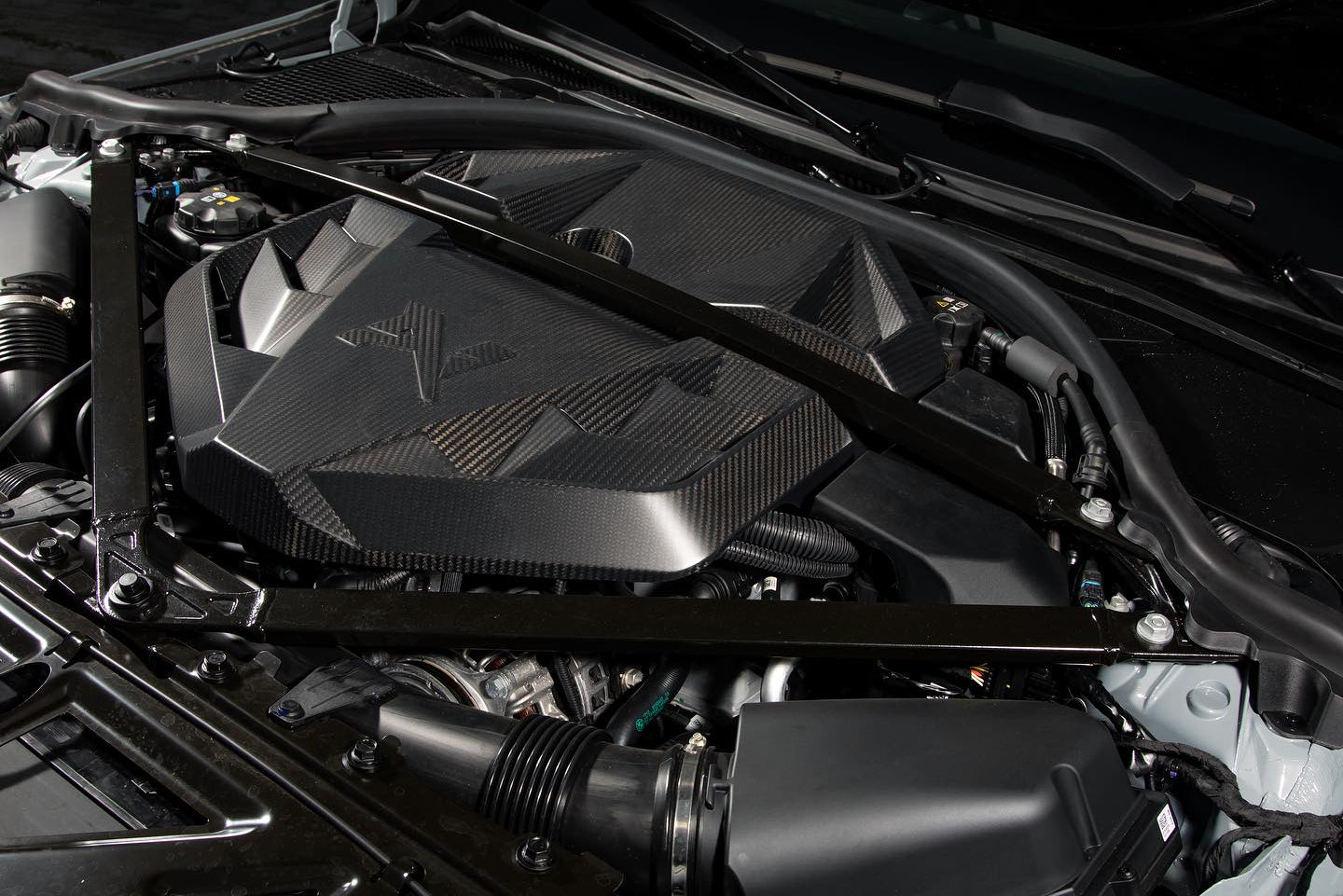 Installed Alpha N G8X S58 Carbon Engine Cover on BMW M2, M3, or M4 showing sleek black carbon fiber exterior design.