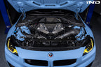 Alpha N G8X S58 carbon engine cover installed on exterior of BMW M2, M3, or M4 with sleek carbon fiber finish.