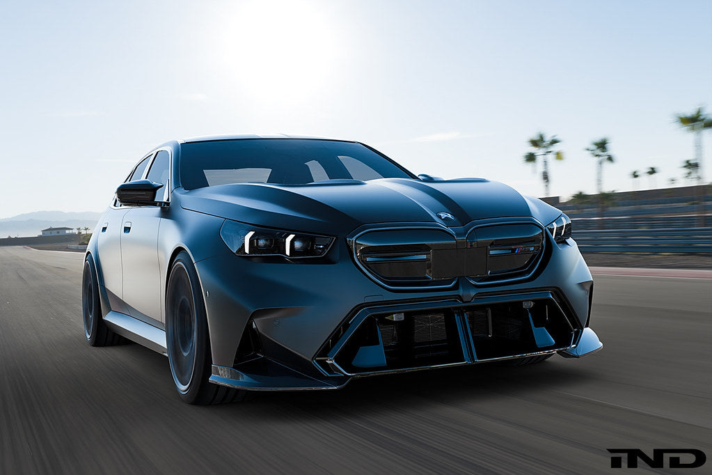 Alpha N G90 G99 M5 carbon front corner splitter set installed on a vehicle's exterior, showing the sleek, aerodynamic design.