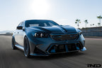 Alpha N G90 G99 M5 carbon front corner splitter set installed on a vehicle's exterior, showing the sleek, aerodynamic design.