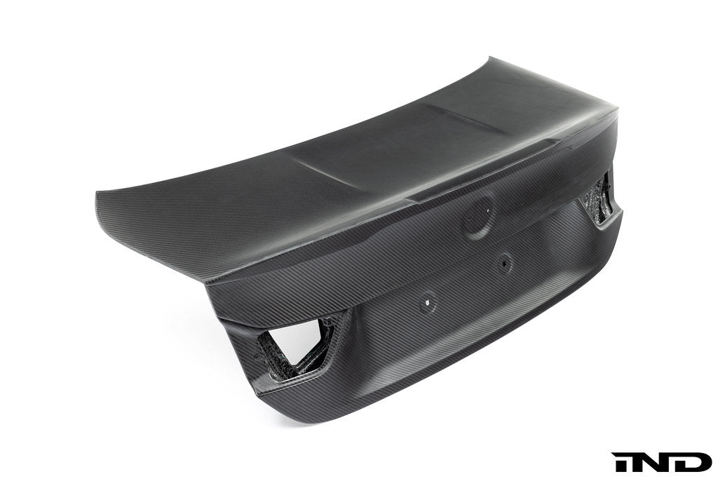 RKP Alpha-N F82 M4 carbon trunk exterior with white background, showcasing sleek aerodynamic design and lightweight carbon fiber material.
