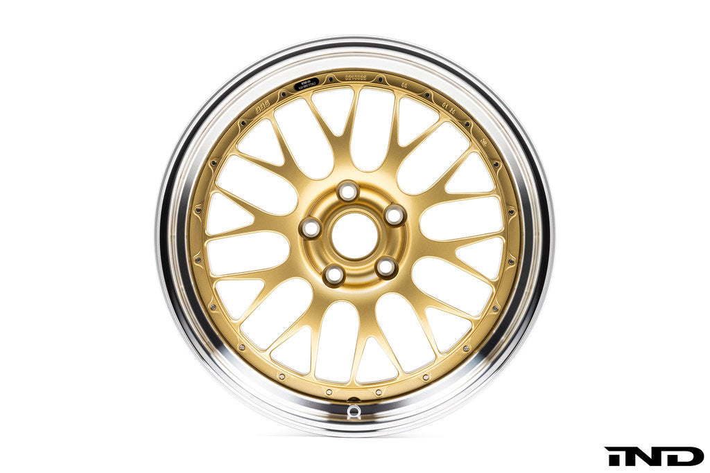 Front facing view of one of BBS' RT-88 wheels showing a gold multi-spoke center and Black Bright Diamond-Cut outer rim against a white background.