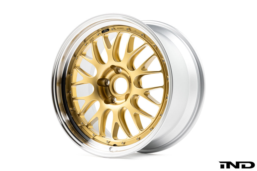 3/4 front view of one of BBS' RT-88 wheels showing a gold multi-spoke center and Black Bright Diamond-Cut outer rim against a white background.
