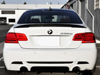 AutoTecknic E92 M3 Carbon Performante trunk spoiler mounted on car exterior, showcasing sleek aerodynamic design and carbon fiber construction.