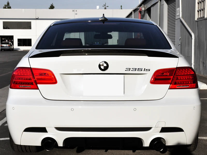 AutoTecknic E92 M3 Carbon Performante trunk spoiler mounted on car exterior, showcasing sleek aerodynamic design and carbon fiber construction.