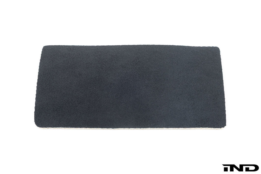 BMW E46 M3 CSL interior center console with Alcantara pad, showcasing black suede-like material and smooth stitching details.