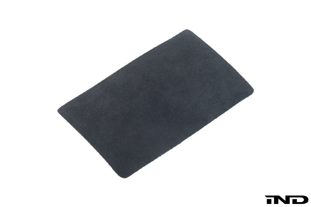 BMW E46 M3 CSL interior center console with Alcantara pad, showing soft, textured black material on the console surface.