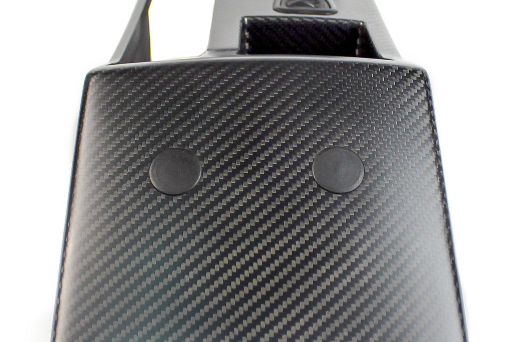 Interior view of a BMW E46 M3 CSL center console trim kit by IND with installed 23mm blind plugs.