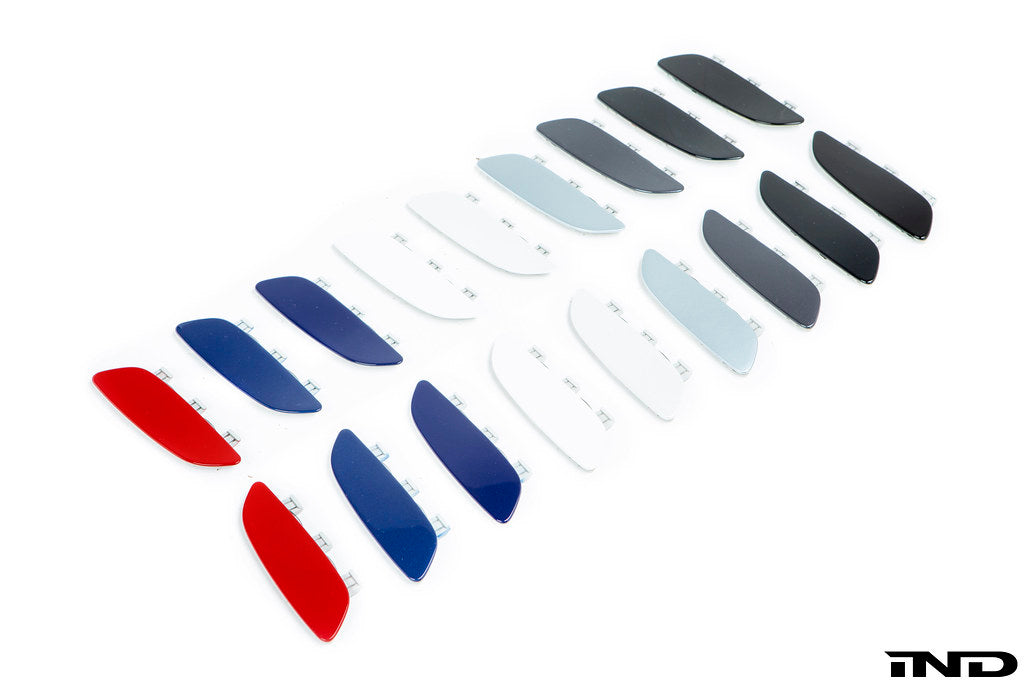Group photo of the IND Painted Front Reflector Set for the BMW E90, E92, and E93 M3, showcasing 11 OEM BMW color options painted using genuine BMW reflector cores.