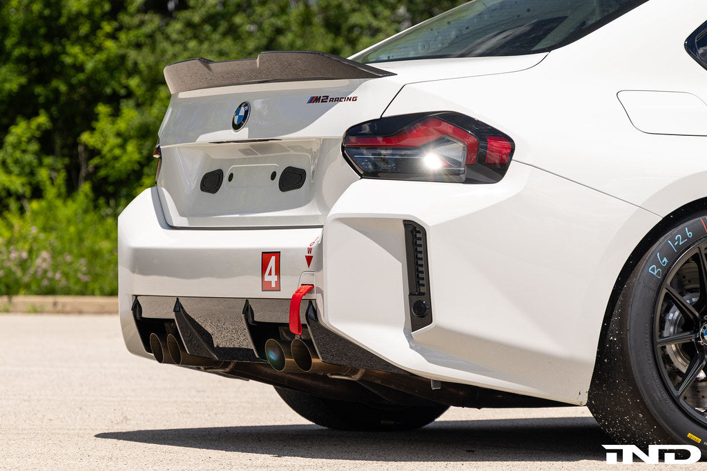 BMW G87 M2 Racing with Acexxon Rear Reflector Insert Set installed, showing the horizontal rear bumper inserts for an OEM+ appearance.