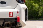 BMW G87 M2 Racing with Acexxon Rear Reflector Insert Set installed, showing the horizontal rear bumper inserts for an OEM+ appearance.