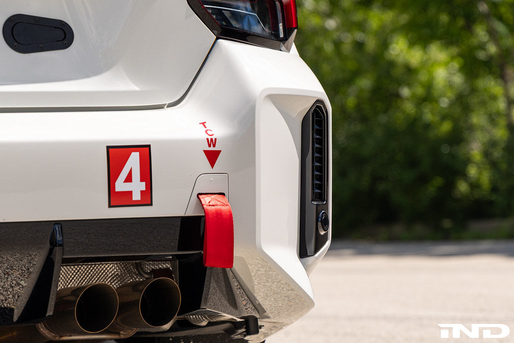 BMW G87 M2 Racing with Acexxon Rear Reflector Insert Set installed, showing the horizontal rear bumper inserts for an OEM+ appearance.