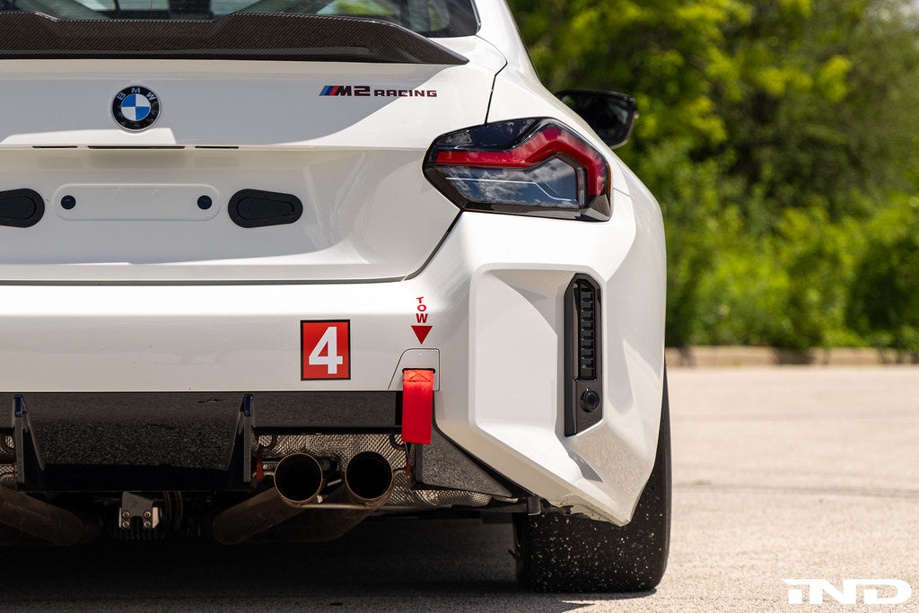 BMW G87 M2 Racing with Acexxon Rear Reflector Insert Set installed, showing the horizontal rear bumper inserts for an OEM+ appearance.