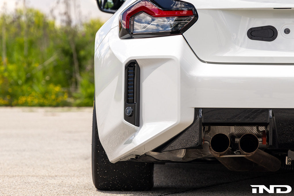 BMW G87 M2 Racing with Acexxon Rear Reflector Insert Set installed, showing the horizontal rear bumper inserts for an OEM+ appearance.